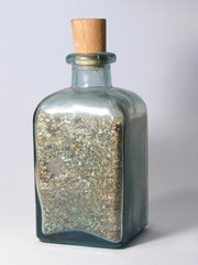 fancy bottle filled with beach-sand