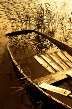 a boat full of water. artistically toned in retro