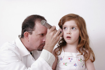 doctor examining a child's ear