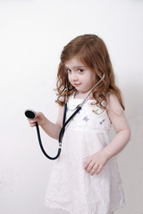 little girl playing with stethoscope