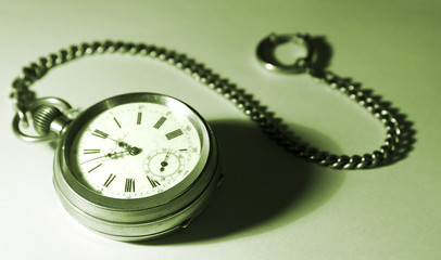 old pocket watch with a chain on a white backgroun