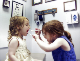 two little girls playing doctor