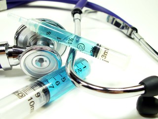 syrings with stethoscope on white