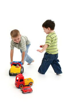 boys playing with cars and trucks