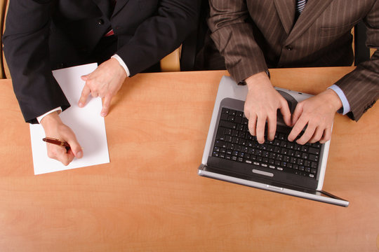 Two Business Men Working At The Desk