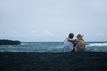 couple sitting on the sand