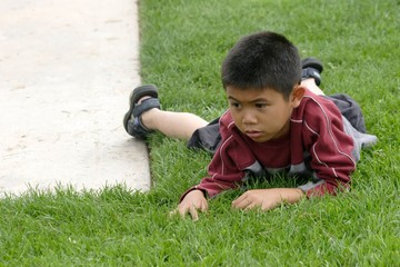 boy resting on the grass