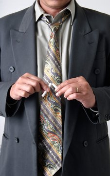 stock photo of man breaking a cigarette