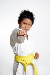 boy with yellow belt practicing karate