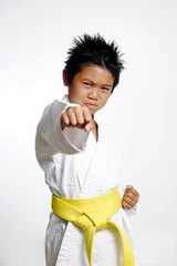 Keuken foto achterwand Vechtsport boy with yellow belt practicing karate