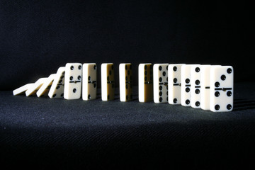 dominoes falling from back