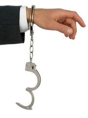 businessman's hand in handcuffs