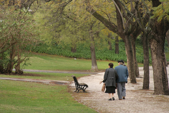 Mature Couple Walking In Park