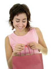 young woman looking into shopping bag