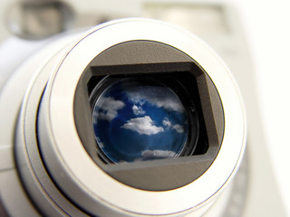 camera with clouds in len