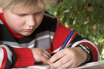 teenager boy writing his exercise