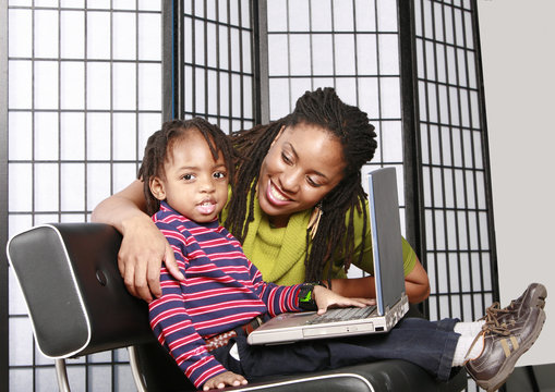 little boy with his mommy and a pc