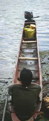 Tuinposter embera indian sitting in dugout canoe © Paul Retherford