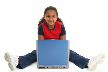 child on floor with laptop