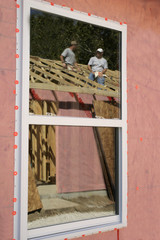 construction workers in window reflection