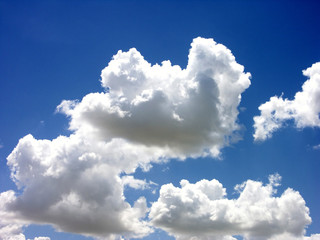 white puffy clouds against bright blue sky