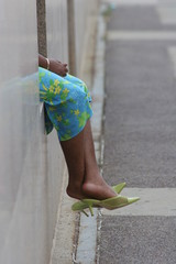 womens feet in green shoes with turquois pants