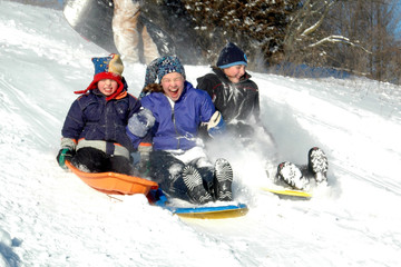 three kids sledding