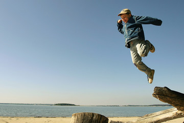 jumping boy on the spring beach
