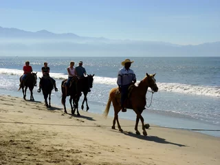 Door stickers Horse riding horseback riders at the beach