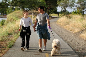 couple walking their dog in the park