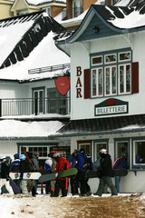 snowboarders lining up to buy tickets