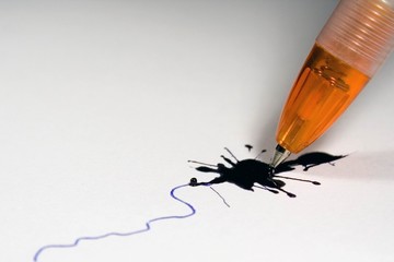 broken ballpoint pen and ink splash