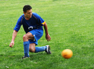 soccer player hitting a ball