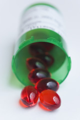 red pills and prescription bottle