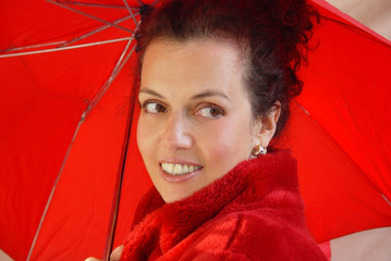 attractive middleaged woman with red umbrella