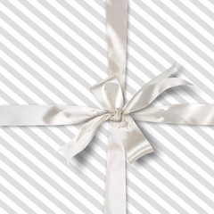 grey striped gift and white satin ribbon