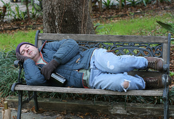 homeless man on bench - full view