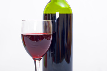 glass and bottle of red wine with white background