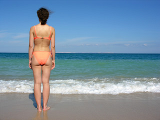 behind girl on beach