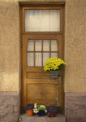 door of an old house and flowers