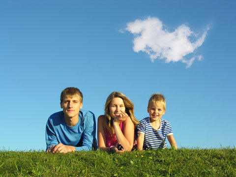 family on herb under blue sky