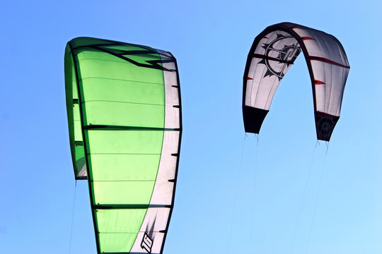 kitesurfing kites against a blue sky