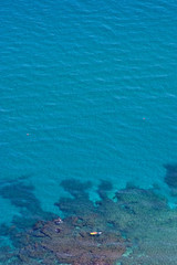 aerial view of clear blue water and yellow boat