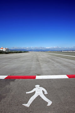 symbol of walking man on runway at gibraltar airport
