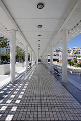 four long converging lines from inside a walkway in modern squar