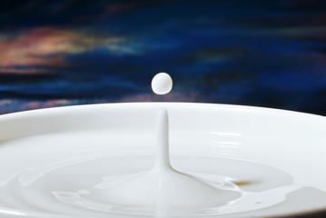 milk dripping into a large bowl of milk with a peak and ball of