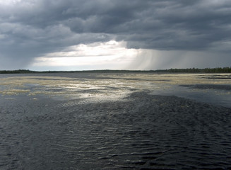 water landscape with clouds and rain