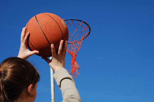 Young Girl Taking Aim With A Basketball