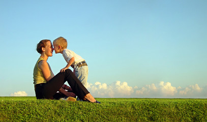 mother with son on sundown kiss by nose. long.