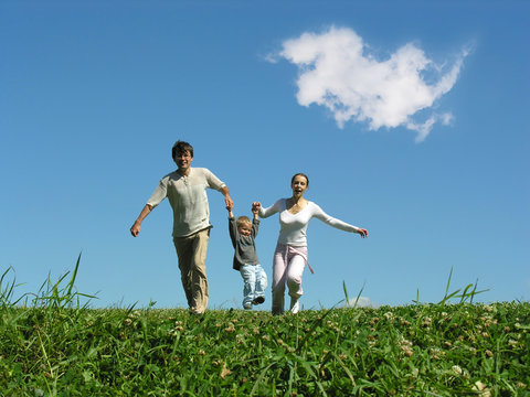 Family On Herb Under Blue Sky